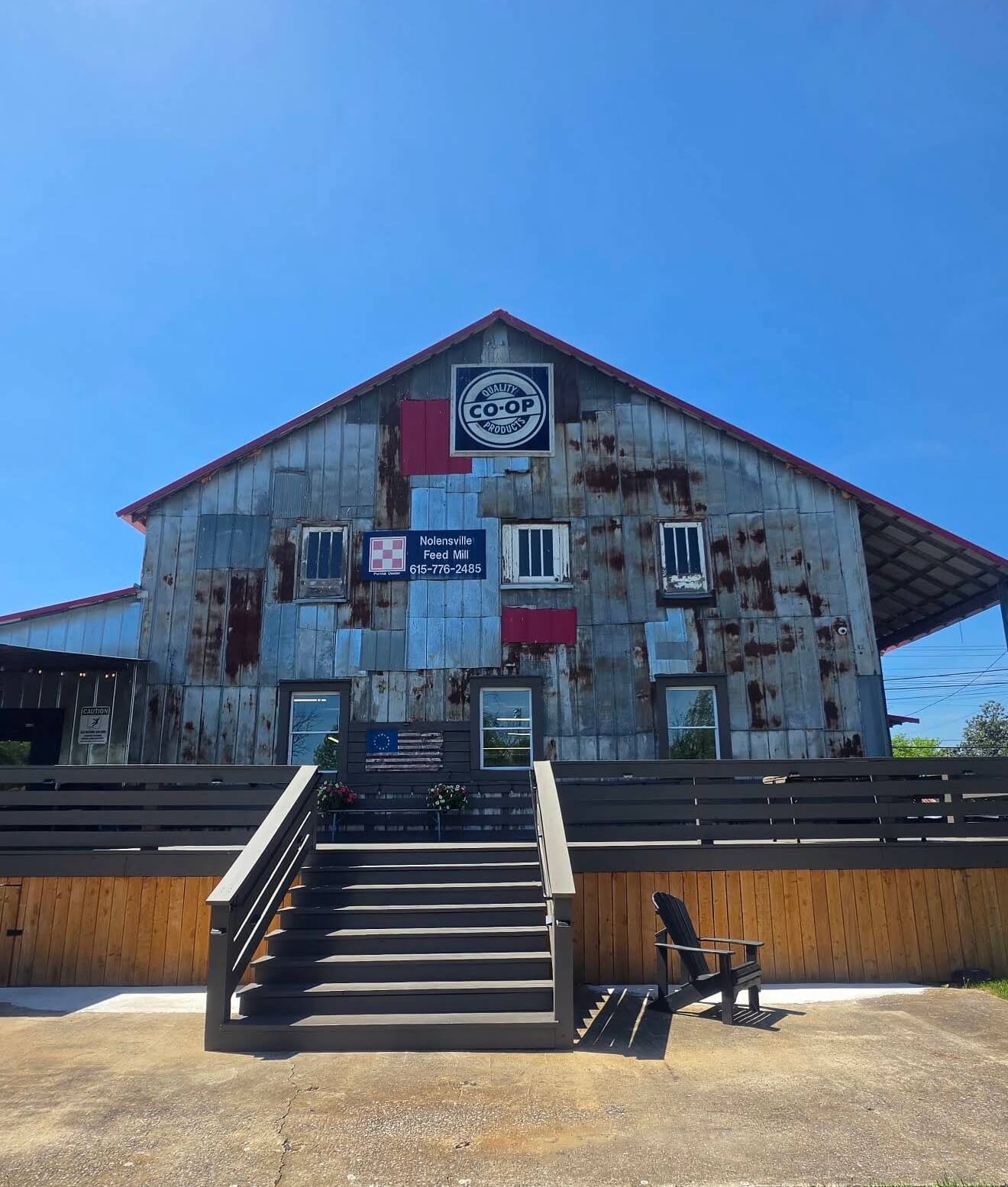 Nolensville Feed Mill Amish Market The rustic Nolensville Feed Mill building features corrugated metal siding and a wooden deck in Williamson County, Tennessee.