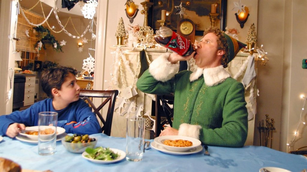 A man dressed as an elf drinks from a large soda bottle at dinner in Williamson County, Tennessee.