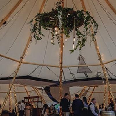 Suspended Wagon Wheel with Greenery and Lighting