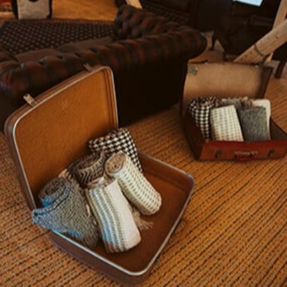5 blankets in a vintage suitcase